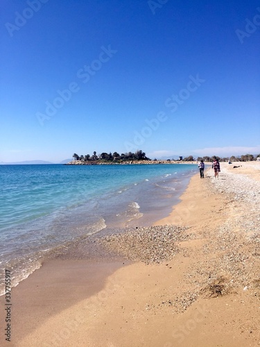 Glyfada Marina, Greece - 20th March 2018 : Peaceful and blue sea wave on the beach in Athens