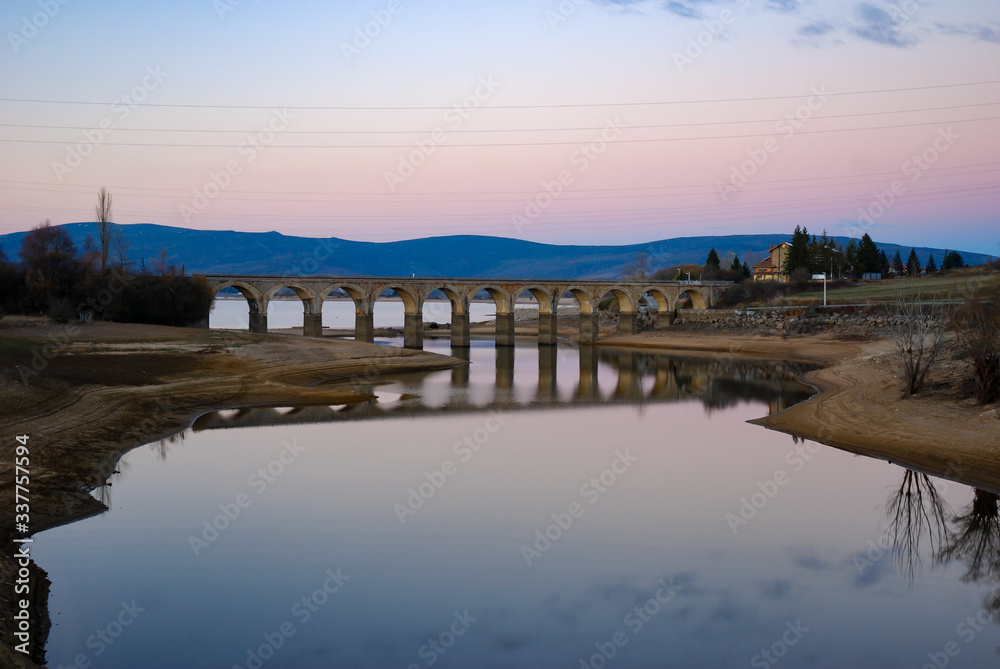 Fototapeta premium lake crossed by a bridge and its reflection