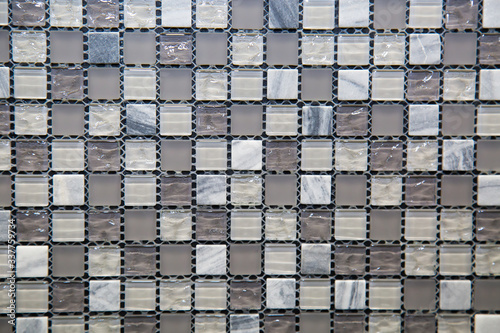 Mosaic of glass and stone in gray and white blue color in the form of small squares. Design backgrounds textures construction