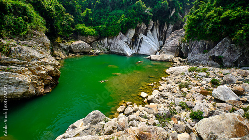 View of the rocks and emerald water at the waterfall in Sapa vietnam