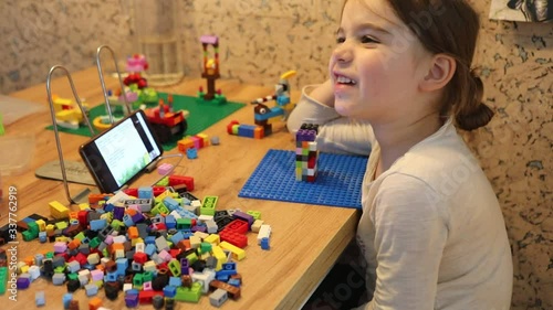 Little girl online learning and creating at home. Quarantine and Social distancing concept.