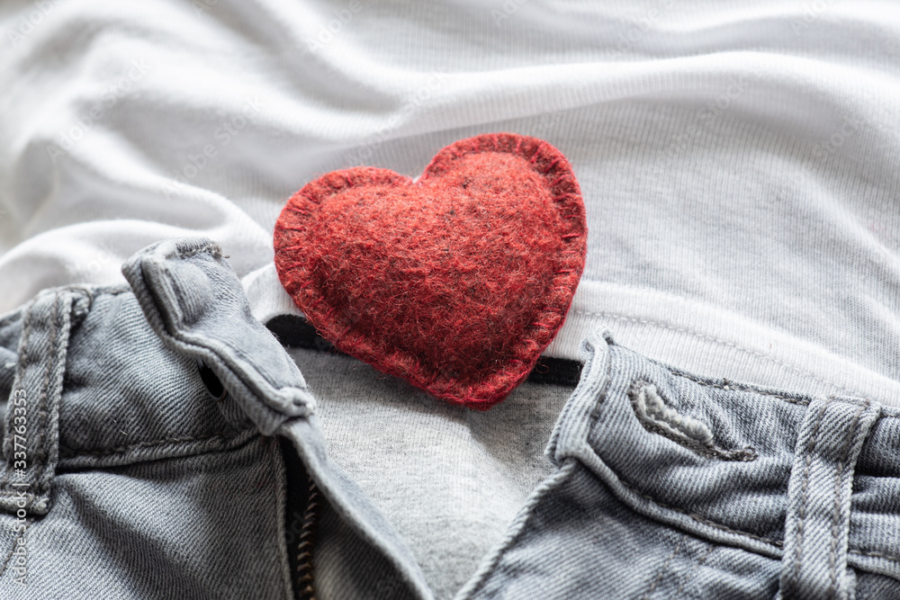 Fototapeta premium open zipper on men's jeans, soft red heart inside, the concept of romantic love, sexual harmony, men's health