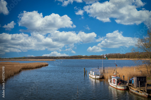 small fishing boats are moored on the banks of  river