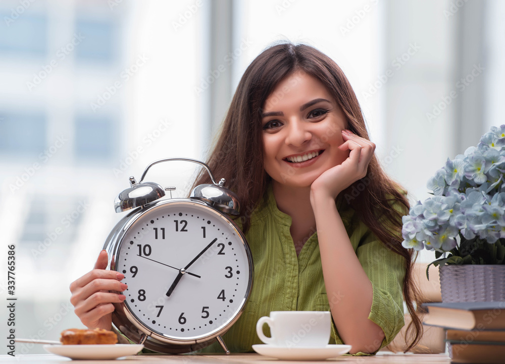 Student with gian alarm clock preparing for exams Student with gian alarm clock preparing for exams