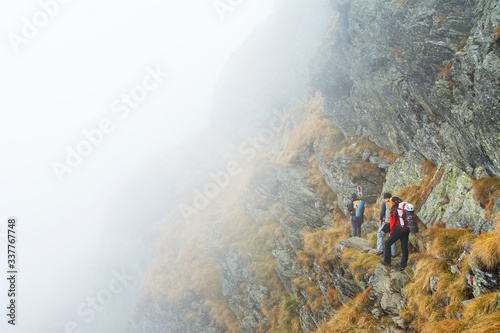 Fototapeta Naklejka Na Ścianę i Meble -  Group of alpinists trekking in the Transylvanian Alps, Romania, Europe