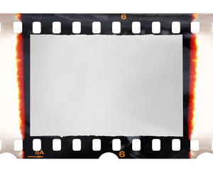 Old fashioned 35mm filmstrip or dia slide frame with burned edges isolated on white background. Real analog film scan with signs of usage.