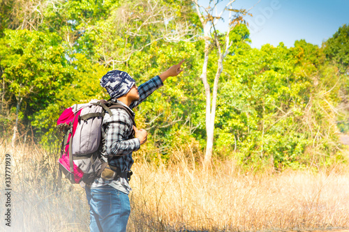 Young man traveler with backpack hiking Lifestyle adventure concept, adventure active summer Forest, Hiking, Journey background.