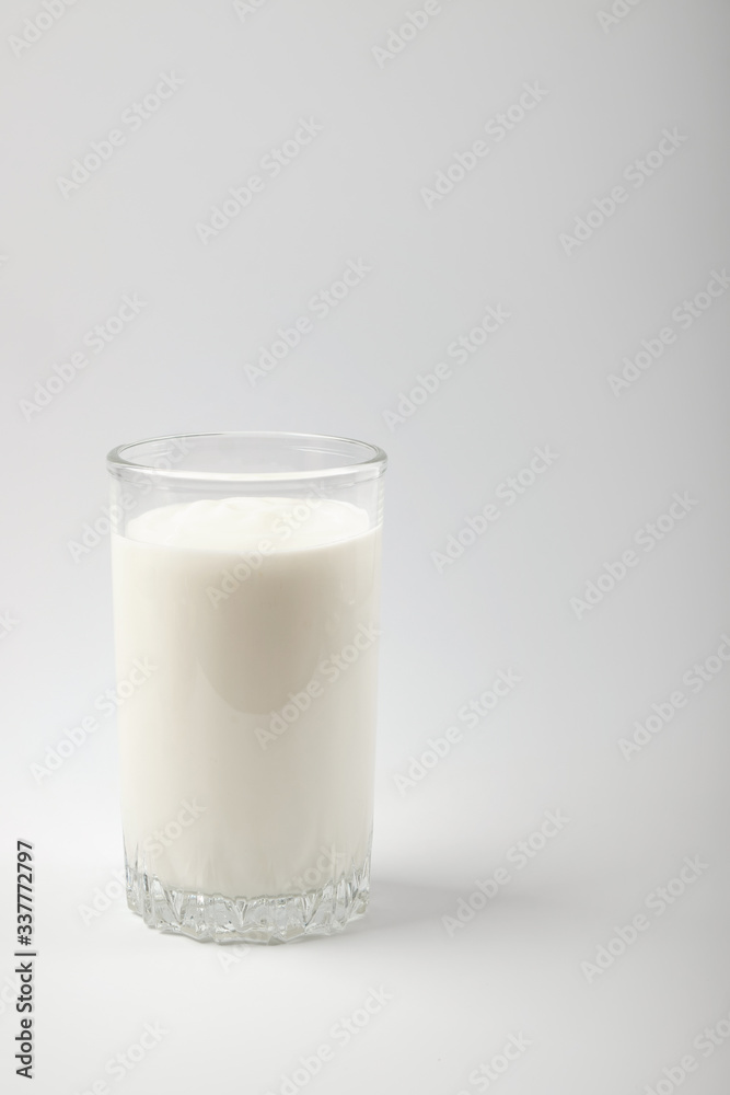 Kefir drink in a bottle and glass on a white background.Sour milk drink Kefir drink in a bottle and glass on a white background.Sour milk drink