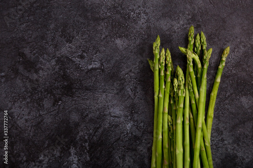 Copy space with asparagus at dark concrete background