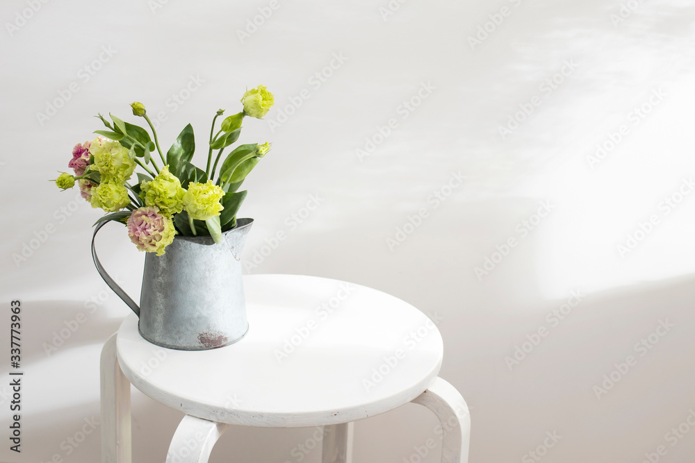 Bouquet of green and pink terry lisianthus and eucalyptus branches in a tin jug vase on white background. Bride bouquet Bouquet of green and pink terry lisianthus and eucalyptus branches in a tin jug vase on white background. Bride bouquet