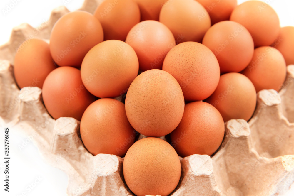 Chicken eggs on a white background in an organic box