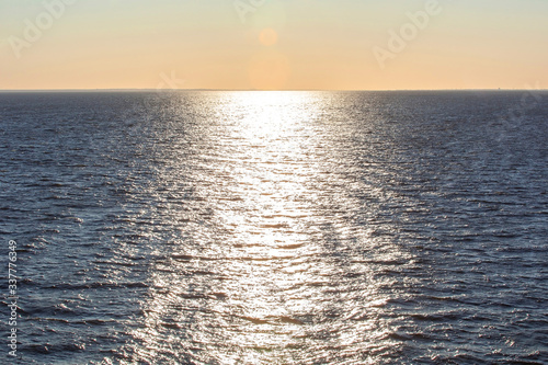 The golden lights shines on the water surface in sunset