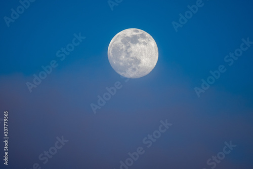 Full moon photographed on an early spring evening.