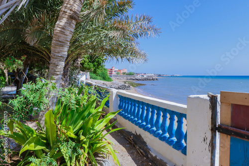 Tadjoura  Djibouti - November 09  2019  Palms and Boats on the Sea Coastline under Blue sky