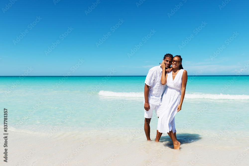 Happy, young couple posing at the tropical beach. Copy space Happy, young couple posing at the tropical beach. Copy space