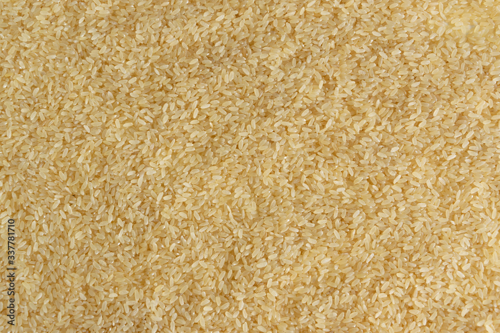 Biological brown rice background, whole grain uncooked cereal ingredient
