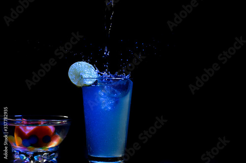 glass, splash, drink, cocktail, water, alcohol, martini, liquid, beverage, blue, cold, bar, ice, isolated, splashing, drop, fresh, party, bubble, pouring, vodka, wet, white, cool, refreshment © Hari