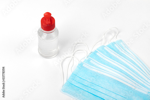 Medical mask and alcogel on a white background