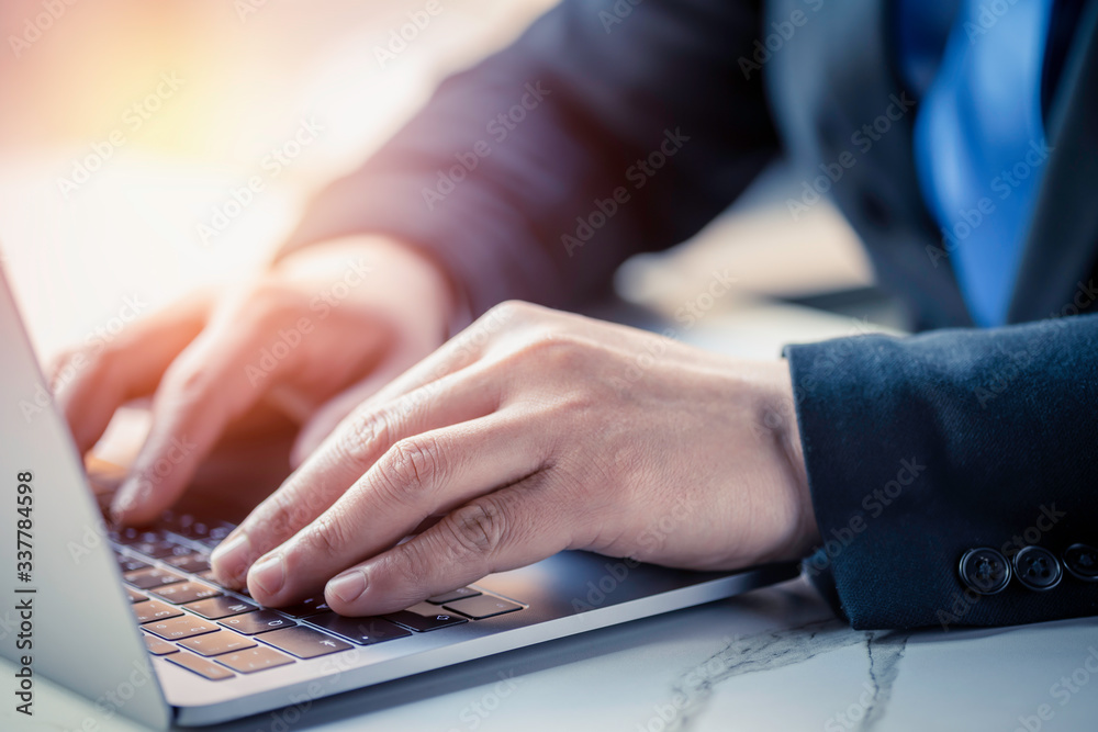 Business man hand typing on laptop computer keyboard. Business and technology concept Business man hand typing on laptop computer keyboard. Business and technology concept
