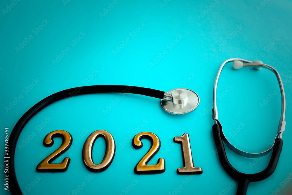 Stethoscope with 2021 number on blue background. Happy New Year for health care and medical banner/calendar cover. Stethoscope with 2021 number on blue background. Happy New Year for health care and medical banner/calendar cover.