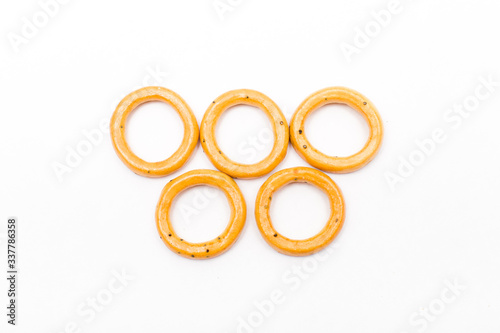 bagel olympiad symbol, cookie circles, white copy space background, baked pastry circles.