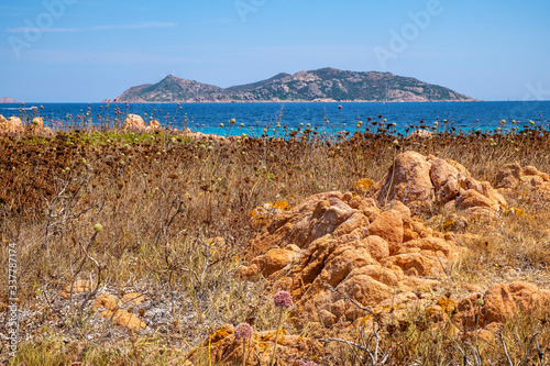 Panoramic view of Spalmatore di Terra peninsula of Marine Protected Area natural reserve with Mediterranean scrub of Isola Tavolara island on Tyrrhenian Sea off northern coast of Sardinia, Italy photo