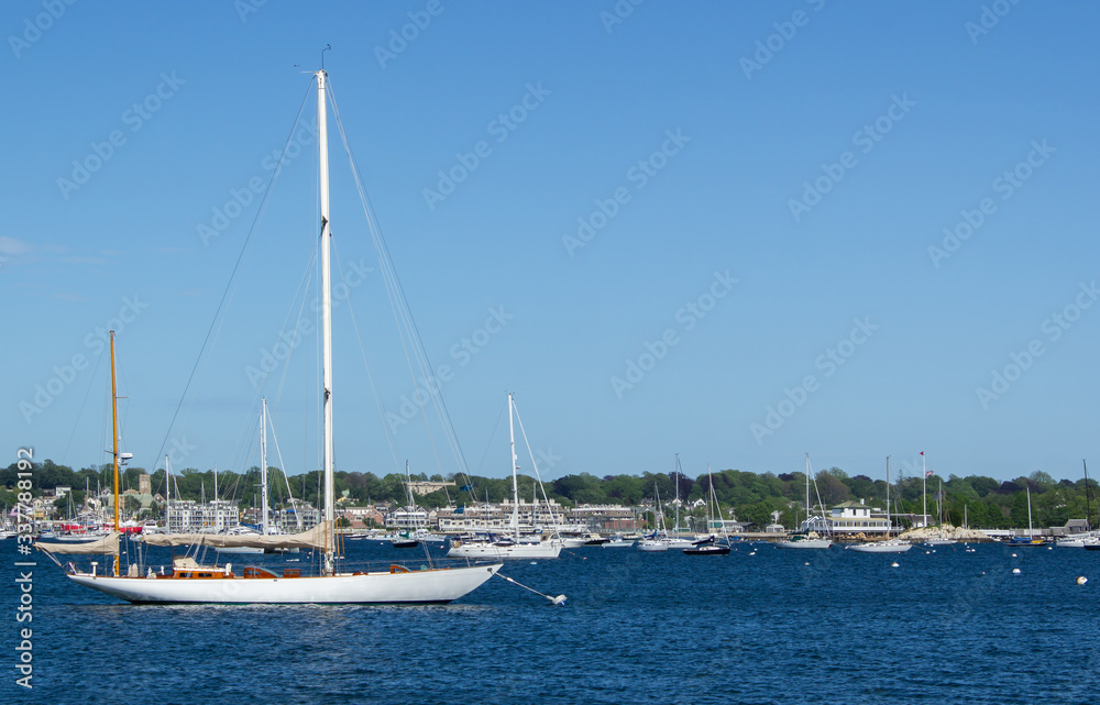 Newport harbor with two-masted sailing ship in foreground