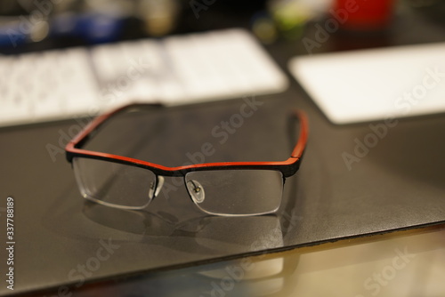 Bright Red Glasses on a desk pad