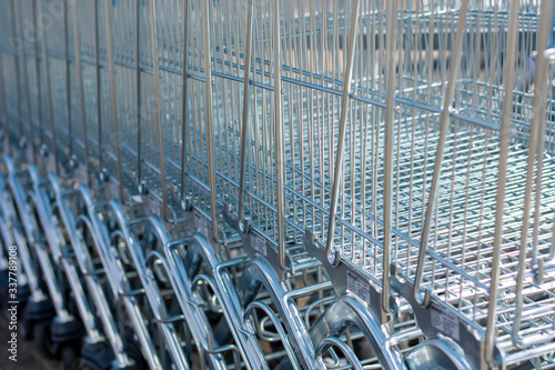 A lot of shopping trolleys. Modern supermarket shopping carts in a row. photo