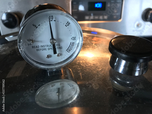Stainless steel pressure cooker at 10 pounds per square inch (PSI) used for canning food