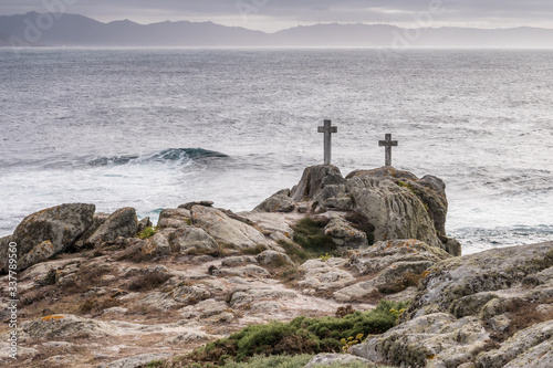 Two crosses on a rock at Cape Roncudo in La Coruña, Galicia, Spain.