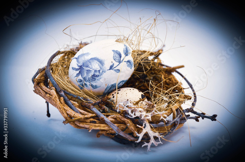 A cute wicker nest with a stingy egg and moss. Easter decoration. Moss. Quail egg.