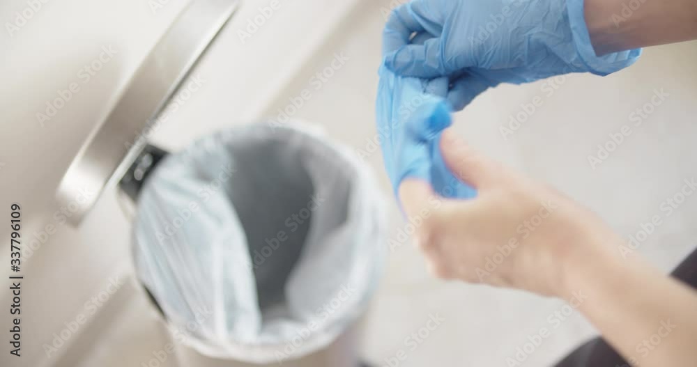 Removing hand gloves and throwing in trash covid 19 pandemic 
