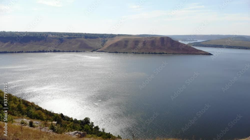 Amazing aerial view on the Dniester Canyon, River and Bakota Bay. Couple walking on mountains. 4K Amazing aerial view on the Dniester Canyon, River and Bakota Bay. Couple walking on mountains. 4K