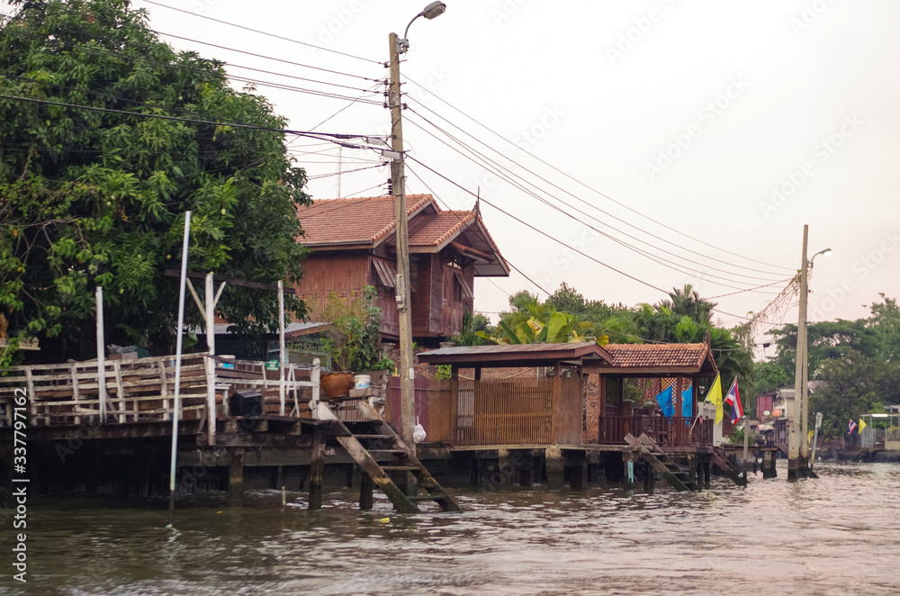 Stilt houses at a klong in Bangkok. Klongs are the canals, that branch off from Chao Phraya river, the big river of Bangkok. The klong is the only way to get to these houses.