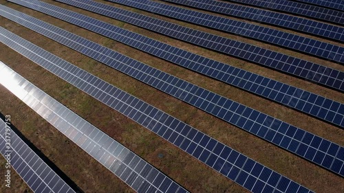 Aerial top down view of Solar energy modules or panels rows. Solar Panels, Alternative energy, Solar Farms. Industrial Energy Farm producing concentrated solar power. Photovoltaic Plant. PV