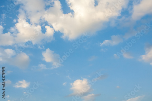 White fluffy cumulus clouds in the blue sky