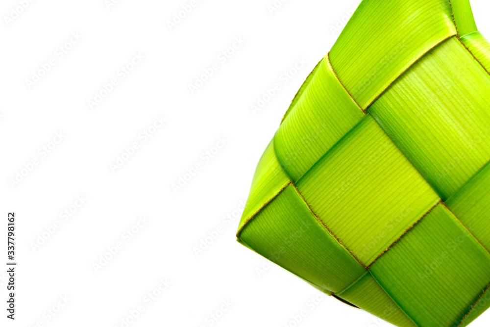Fototapeta premium Ketupat or rice dumpling is a local delicacy during the festive season. Ketupats, a natural rice casing made from young coconut leaves for cooking rice on a white background 