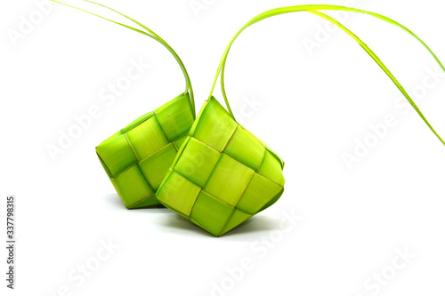 Ketupat or rice dumpling is a local delicacy during the festive season. Ketupats, a natural rice casing made from young coconut leaves for cooking rice on a white background

