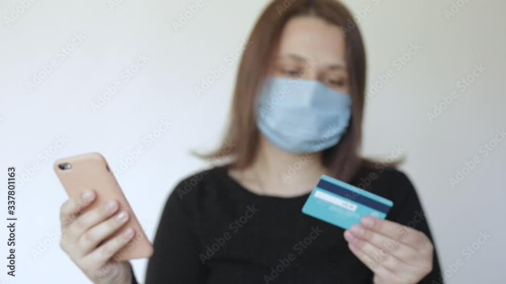 girl in isolation uses a phone and a card to deliver groceries girl in isolation uses a phone and a card to deliver groceries