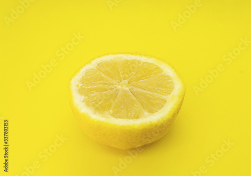 yellow lemon on yellow background top view