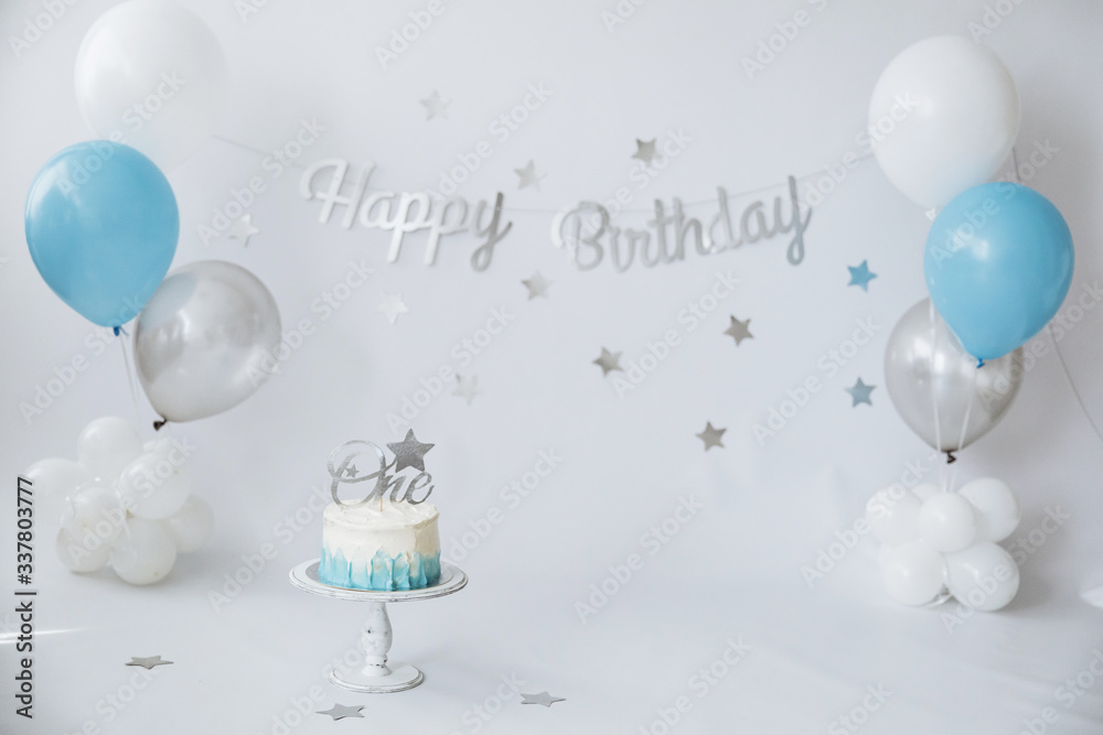 Festive background decoration for birthday celebration with gourmet cake and blue balloons in studio, cake smash first year concept - obrazy, fototapety, plakaty 