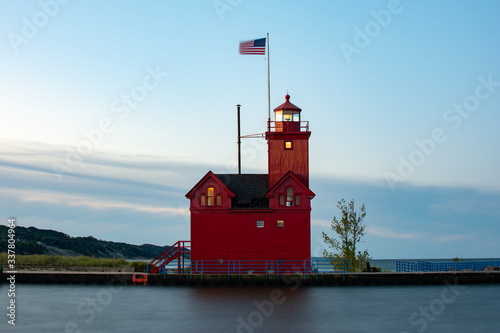 Big Red Lighthouse as the sun rises.  MI, USA. photo