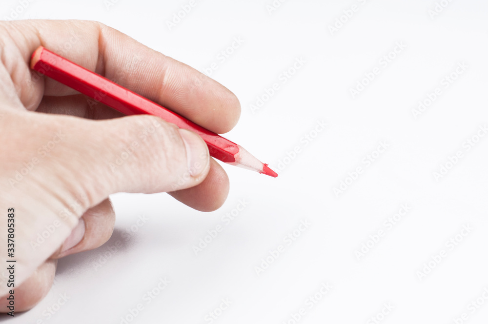 Colour pencils in hand isolated on white background.Copy space Colour pencils in hand isolated on white background.Copy space
