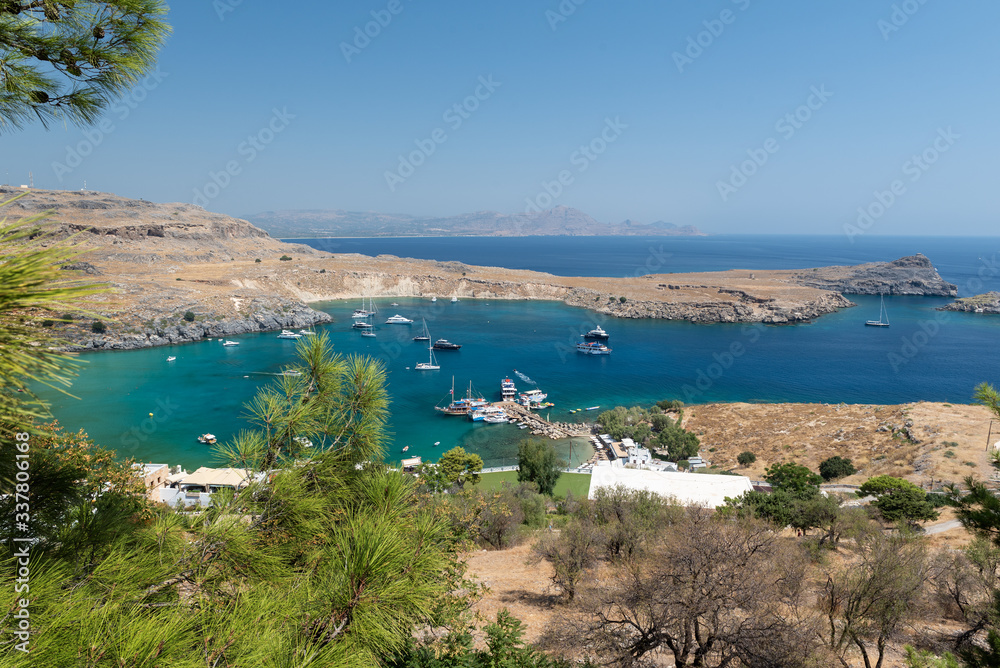 RHODES, GREECE - AUGUST 2020: Blue lagoon with transparent water at Lindos town.