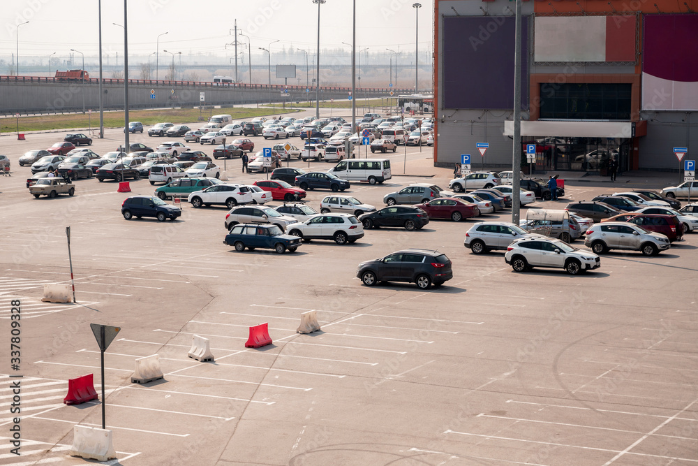 ample parking for cars near the shopping center. people go to the shops. environmental issue of air pollution