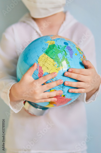 Man in white protective suit respirator mask hold in hand globe world earth isolated on blue background studio. Epidemic pandemic new rapidly spreading coronavirus 2019-ncov medicine virus concept