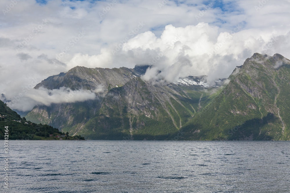 End of fjord. Beautiful Norwegian landscape. view of the fjords. Norway ideal fjord reflection in clear water In cloudy weather. selective focus End of fjord. Beautiful Norwegian landscape. view of the fjords. Norway ideal fjord reflection in clear water In cloudy weather. selective focus