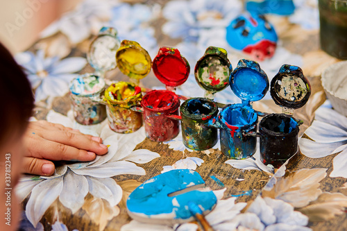 children's hands paint with brushes.fine art, creativity and artistic tools concept.