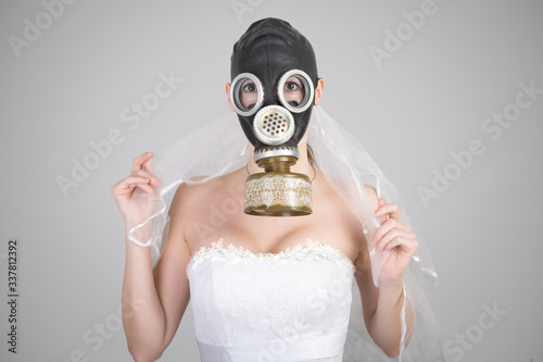 cyberpunk Bride in veil dress and protective gas mask and veil posing. © katafree